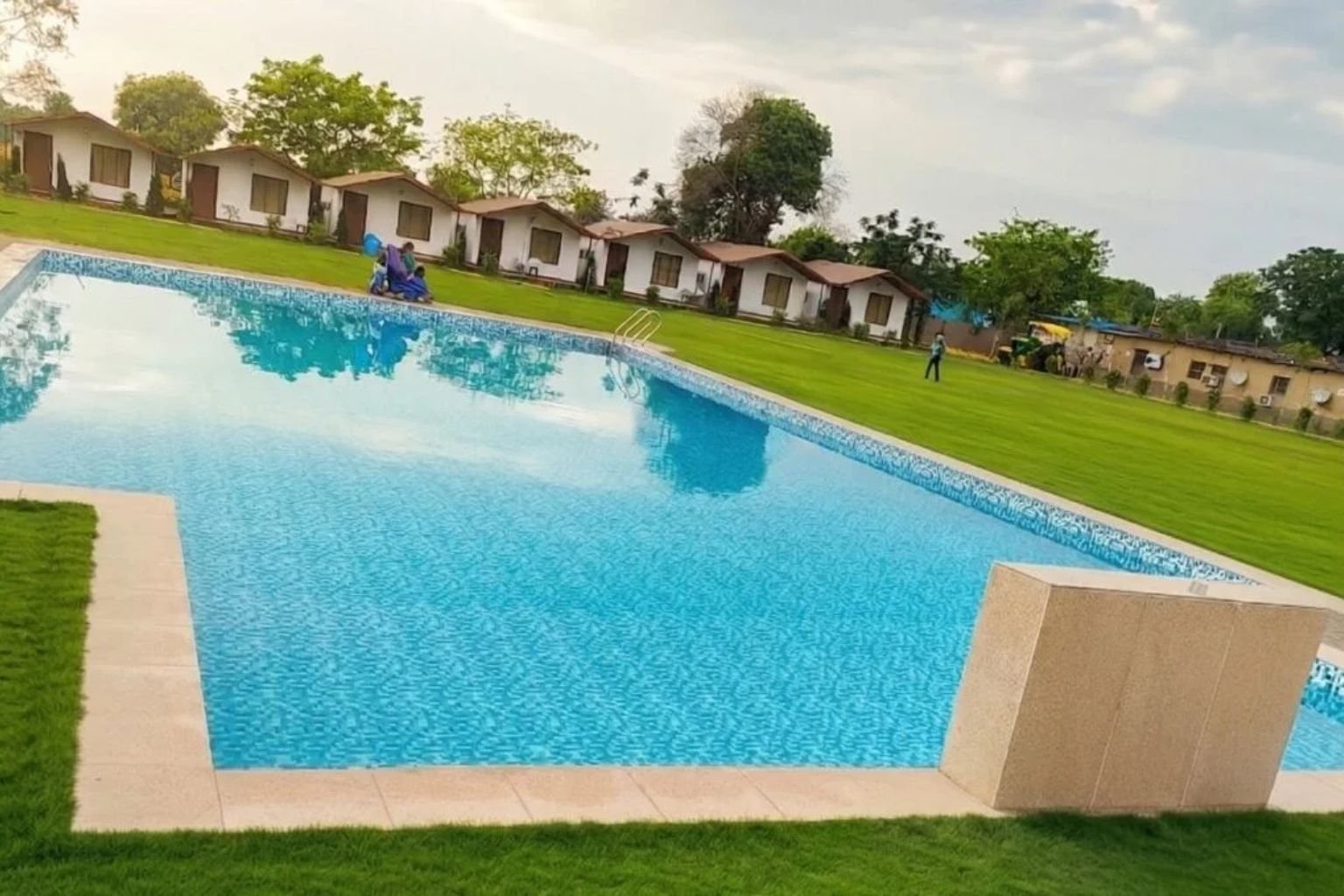 Arise Rustic Village Resort lawns and mud cottages in the Manesar area