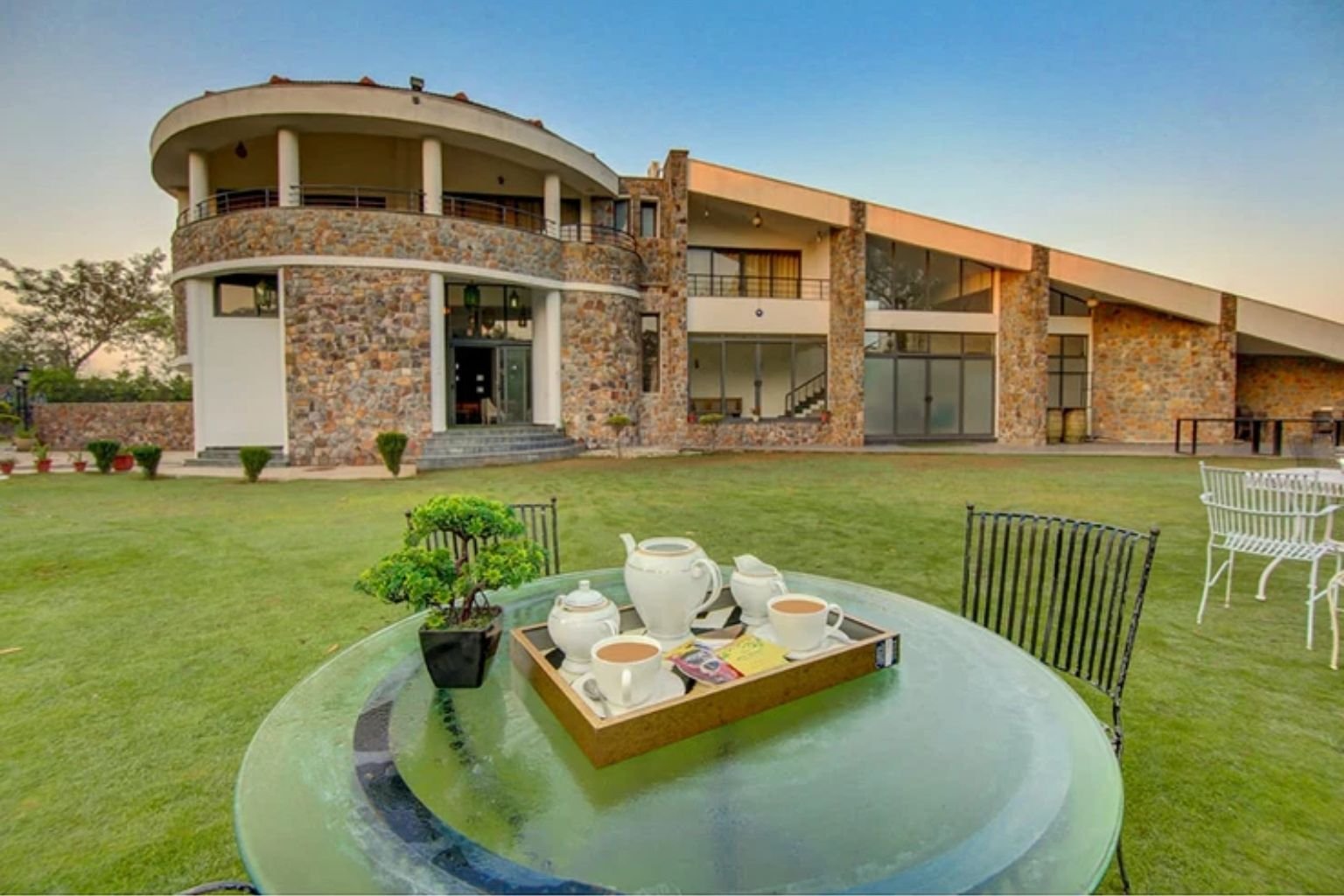 Lit party lawn and pool at a private farmhouse bachelor party venue near Manesar