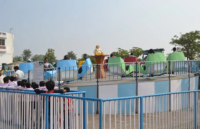 School children queuing for a spinning amusement ride at Club Platinum Resort