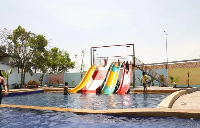Swimming pool with four water slides at Club Platinum Resort