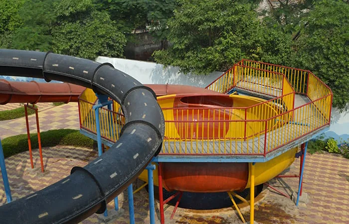 Water park at Club Platinum Resort, Bahadurgarh, with a funnel slide, enclosed tube slides and rider walkways