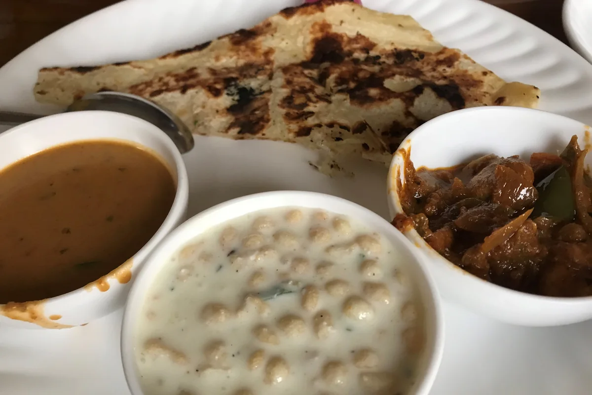 North Indian vegetarian thali served with rice, dal and vegetables — representative photograph