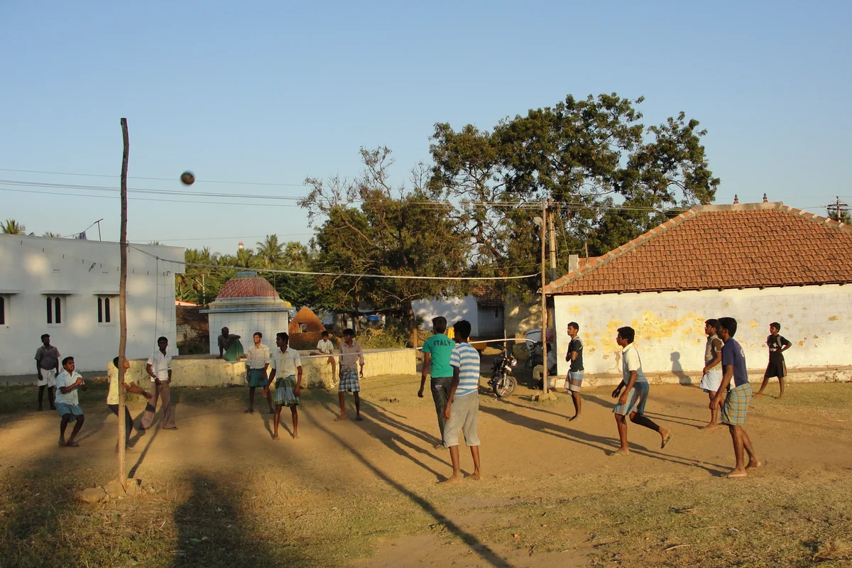 Village volleyball match in progress on an open ground — representative photograph