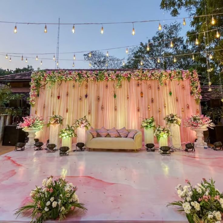 Warm string lights and table decor for an engagement party in a Gurgaon celebration hall