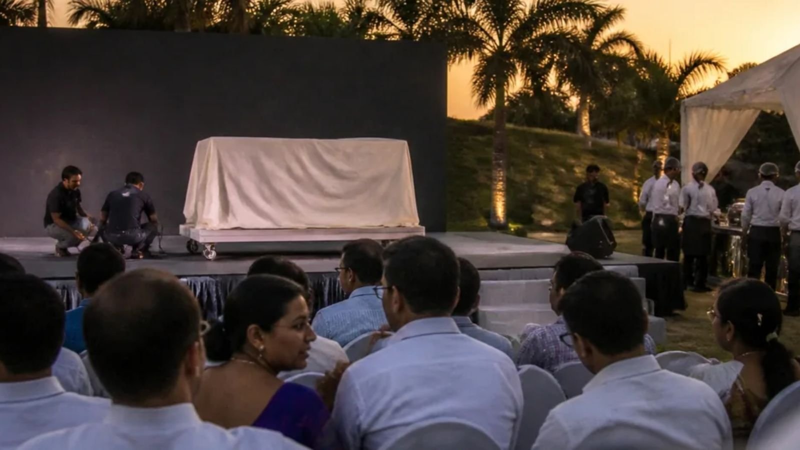 Product launch event setup at a venue in Manesar with a stage, guest seating and a product display area