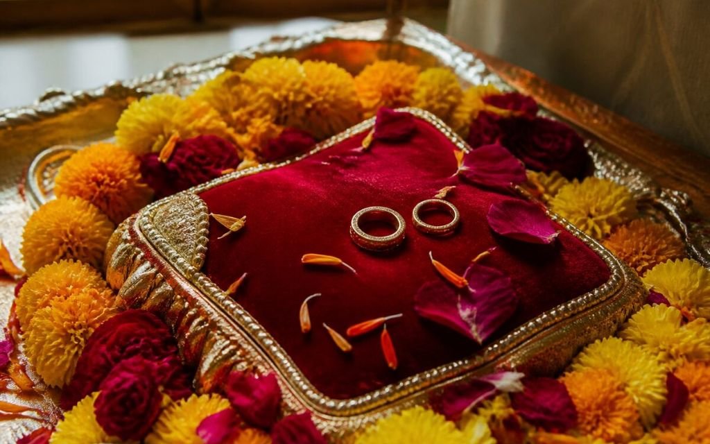 Ring exchange decor with engagement rings on a velvet cushion at an engagement venue in Manesar