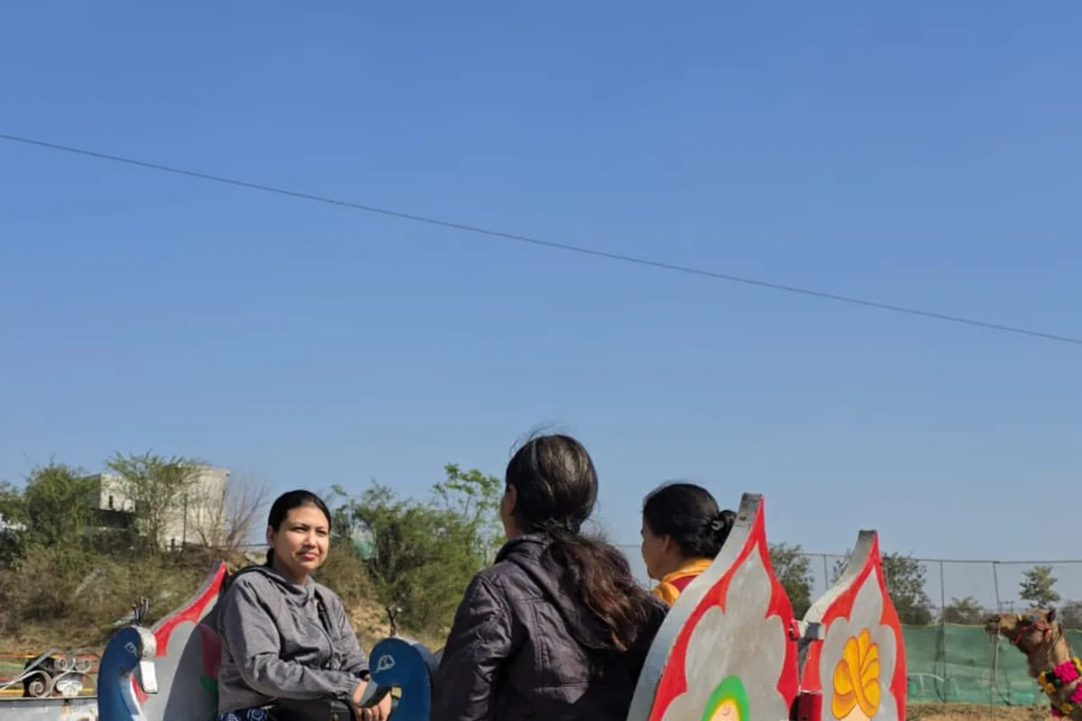 Family enjoying a decorated cart ride during a day outing at Wildvadi Theme Park